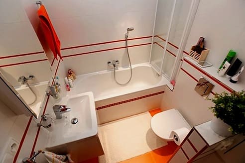 bela in oranžna zasnova kopalnice
